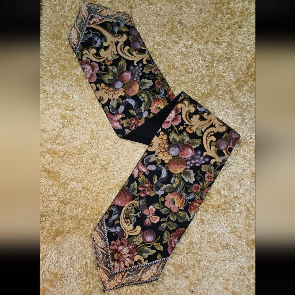 Vintage black tapestry table runner with a fruit and floral pattern.